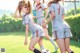 A group of young women playing soccer on a field.