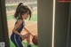 A girl in a blue and yellow uniform holding a basketball.